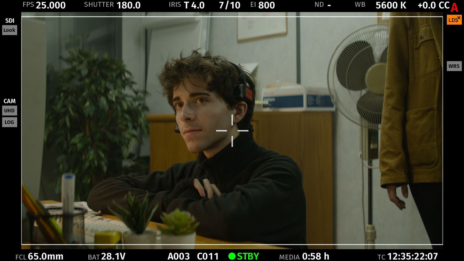 Marcelo Seguí Gill on set, framed on the camera monitor with the shot's exposure data around the edge