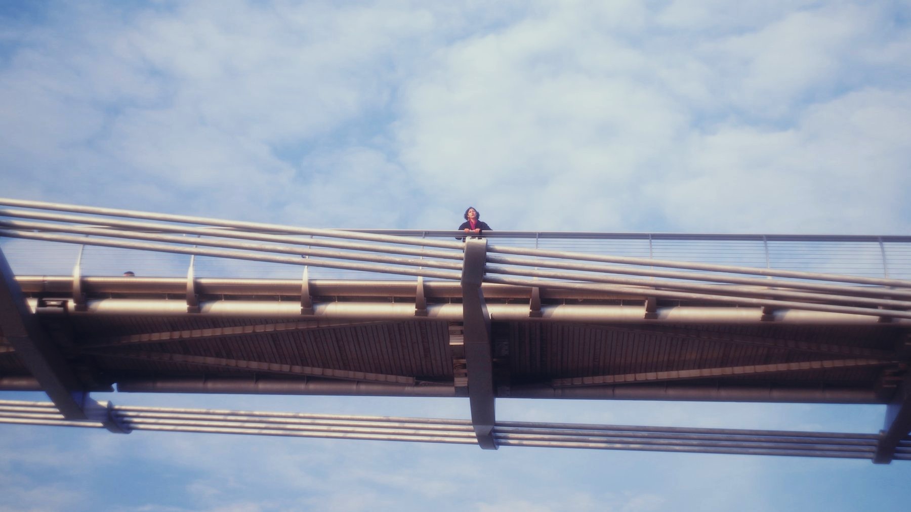 Marcelo Seguí Gill — still from the music video So Lost by Neusha, a woman on a footbridge seen from below