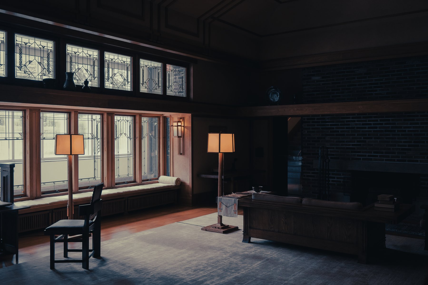 Frank Lloyd Wright-style interior with stained glass windows and warm lamps